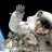 Astronaut Heidemarie M. Stefanyshyn-Piper waves at the camera during a spacewalk (file photo). Photograph courtesy NASA