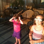 Kalen and Piper with eclipse glasses on
